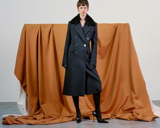 Pre Fall 2024 Best Looks Fashion Shoot featuring woman in double breasted jacket backdropped by draped fabric