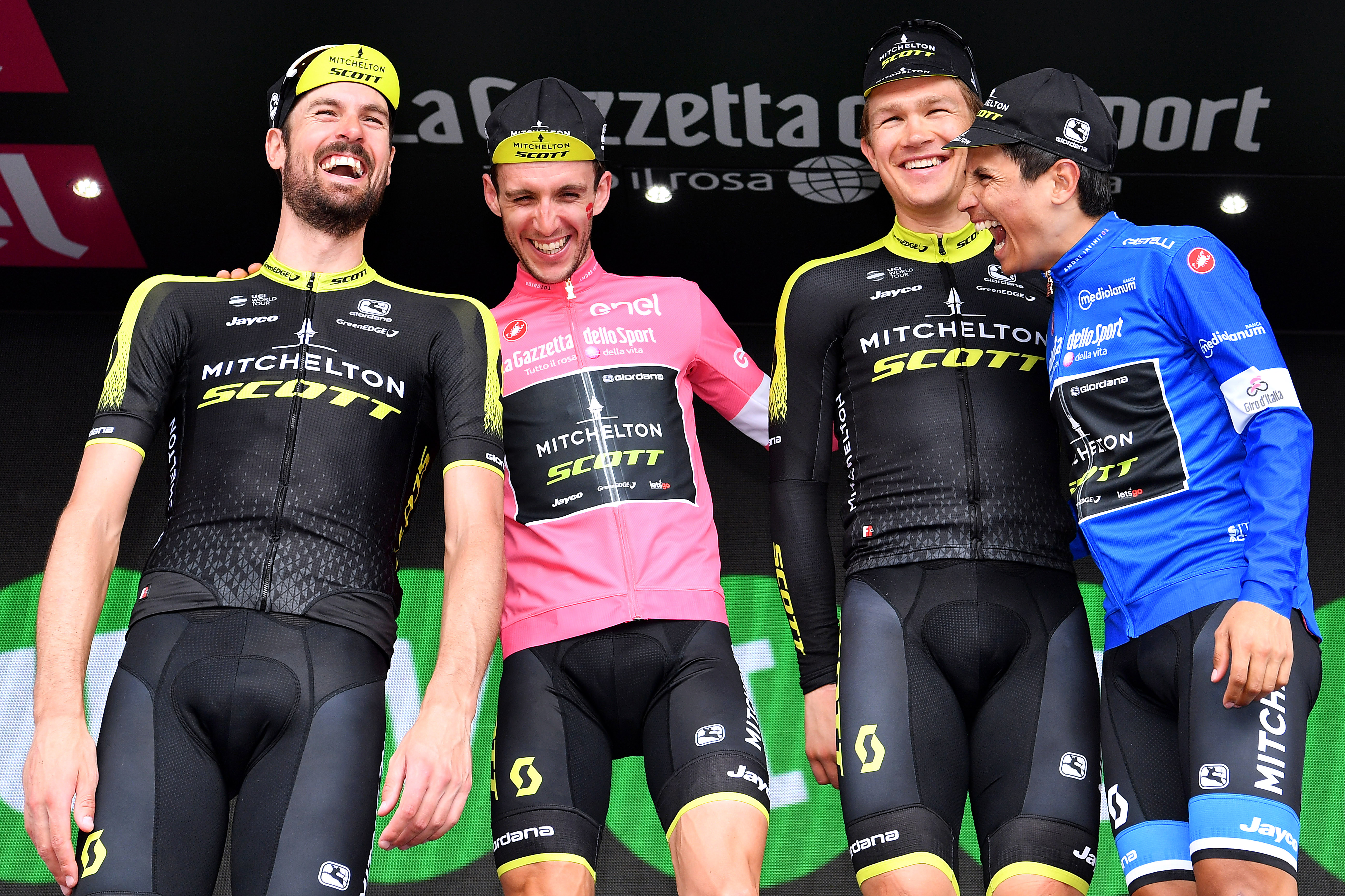 PRAIA A MARE, ITALY - MAY 11: Podium / Sam Bewley of New Zealand and Team Mitchelton-Scott / Simon Yates of Great Britain Pink Leader Jersey / Christopher Juul Jensen of Denmark / Johan Esteban Chaves Rubio of Colombia Blue Mountain Jersey / Team Mitchelton-Scott of Australia / Super Team / Celebration / during the 101th Tour of Italy 2018, Stage 7a 159km stage from Pizzo to Praia a Mare / Giro d&amp;amp;apos;Italia / on May 11, 2018 in Praia a Mare, Italy. (Photo by Justin Setterfield/Getty Images)