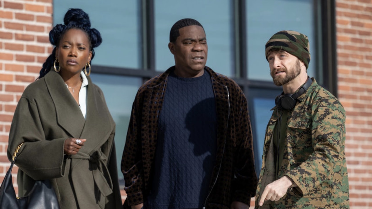 Monica, Reggie and Arthur standing outside of brick building in The Fall And Rise Of Reggie Dinkins