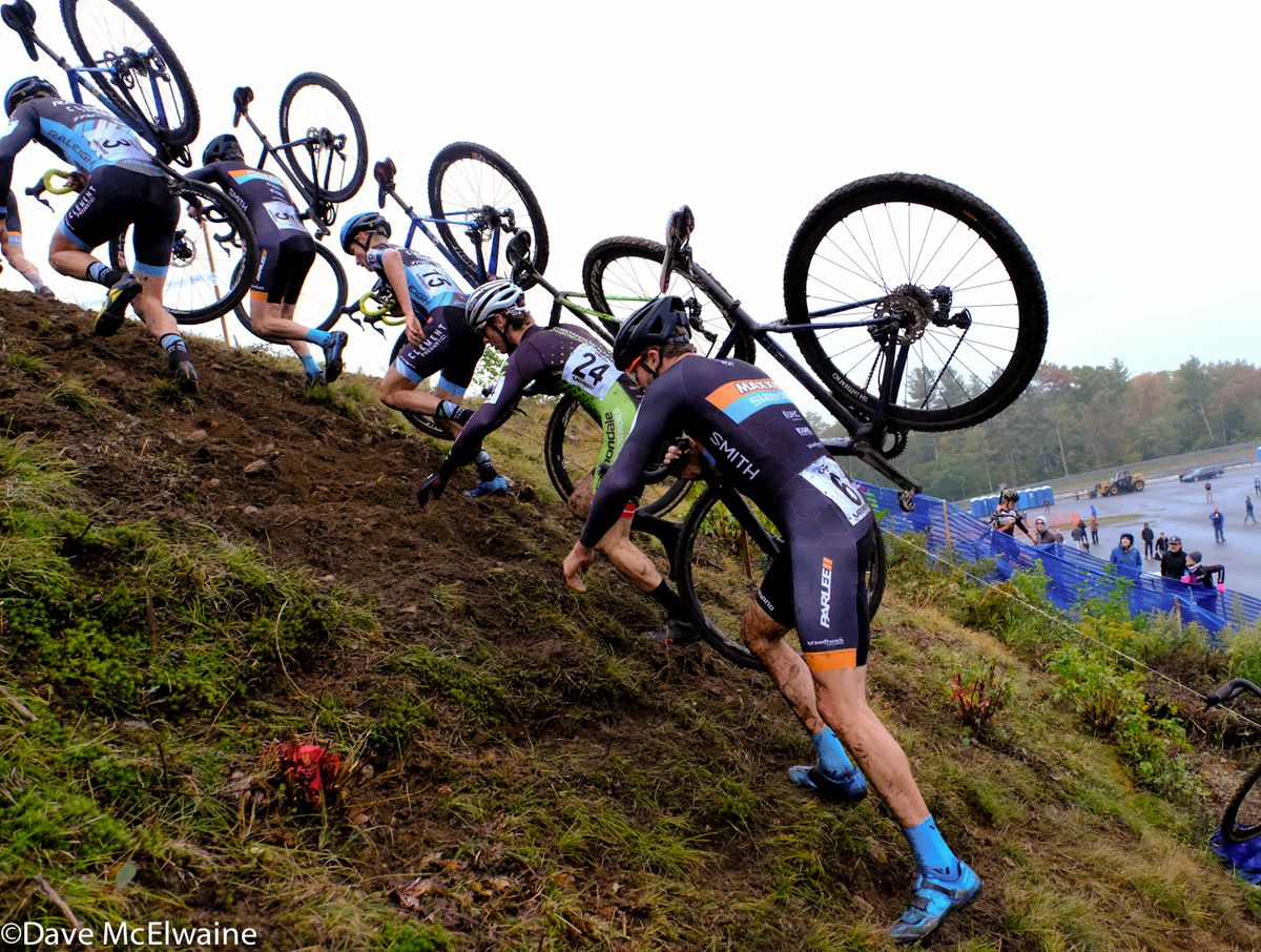 Danny Summerhill (Maxxis Shimano) and other chasers scramble up a steep embankment