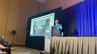 Jesse Schell, CEO at Schell Games, at a podium for his GDC panel, "The Future of MR Experiences". The slide shows "New Genre: Adaptive In-Home Storytelling."