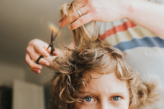 boy having his hair cut during January lockdown