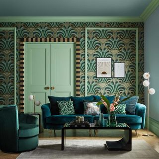 living room with printed wall and blue sofaset