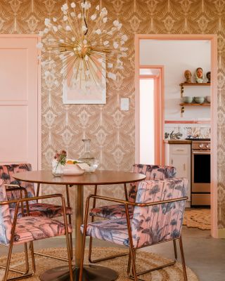 Wallpapered dining room with patterned chairs