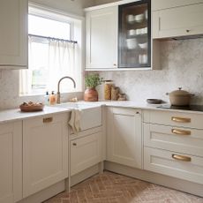 Terracotta tiles with cream cabinets