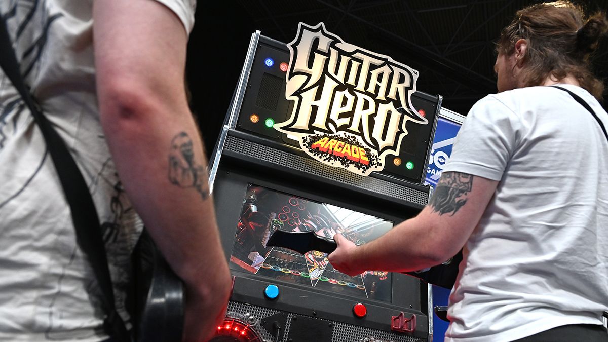 People playing Guitar Hero Arcade