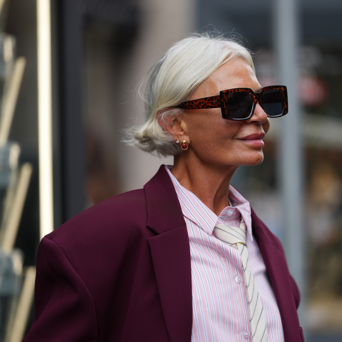 Grece Ghanem wears short platinum blonde bob with burgundy blazer