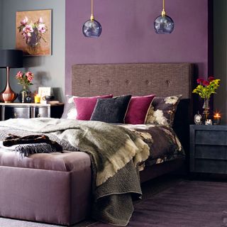 bedroom with purple wall shade and brown headboard