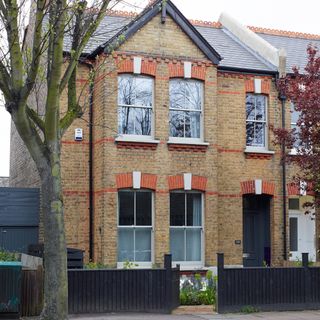 house with brick wall and white window