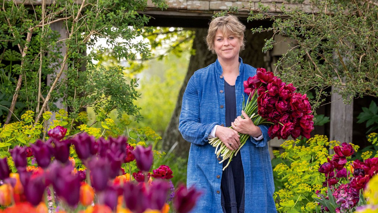 Sarah Raven holding a large bunch of dark pink peonies Small garden colour palette