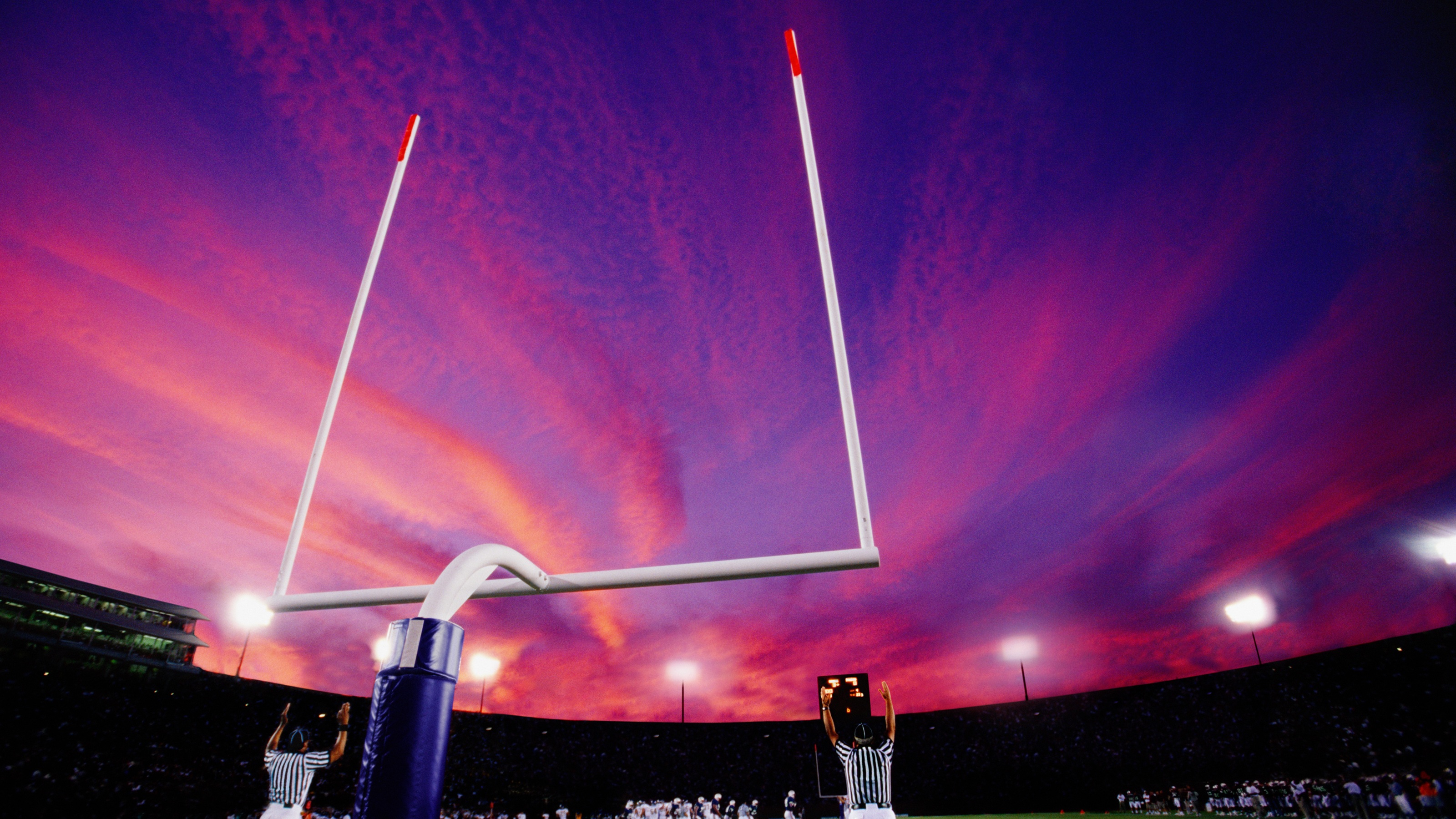Football goalposts at sunset.