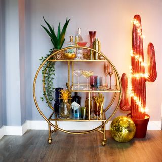 Audenza bar cart with gin and glasses on it