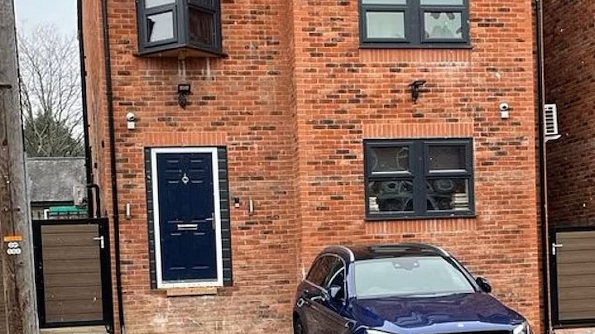 A brick house with a front door that has no steps to access it