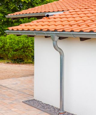 Roof and wall of home with zinc gutters and rain pipe