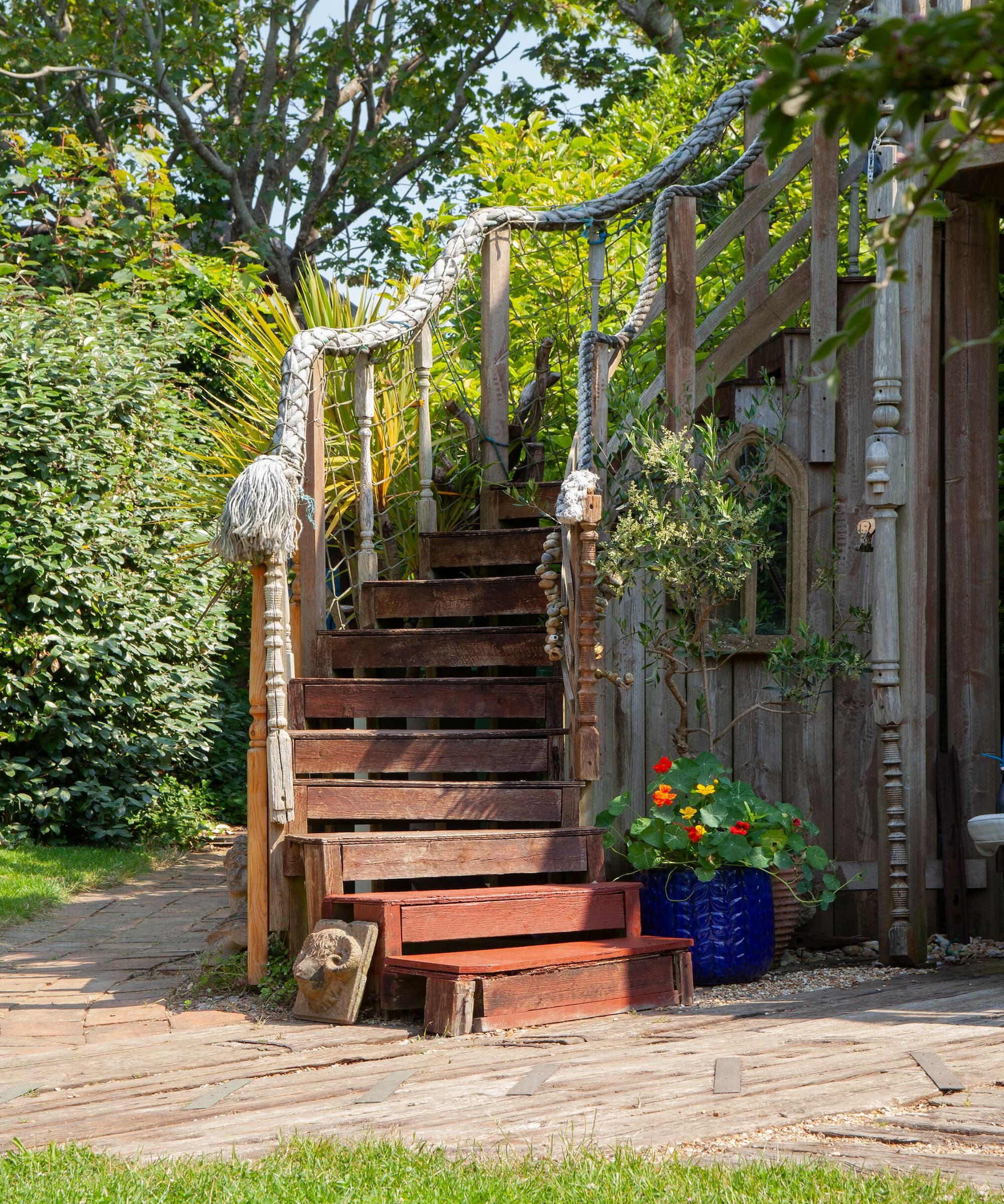 A wooden staircase outside leading to a balcony