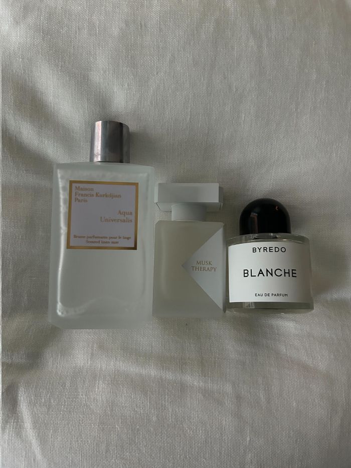 A selection of the best fresh laundry perfumes on a white linen background