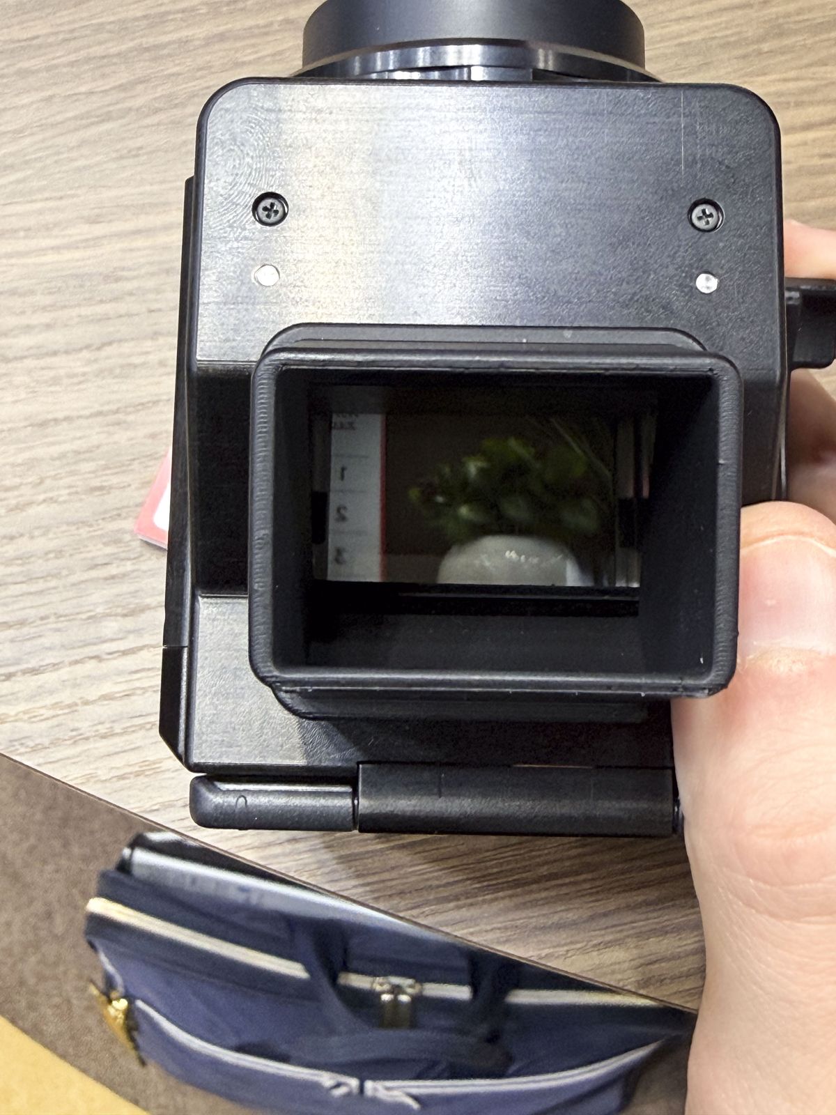 Canon's Analog Concept Camera in users hand at the Canon booth at the CP+ 2026 show