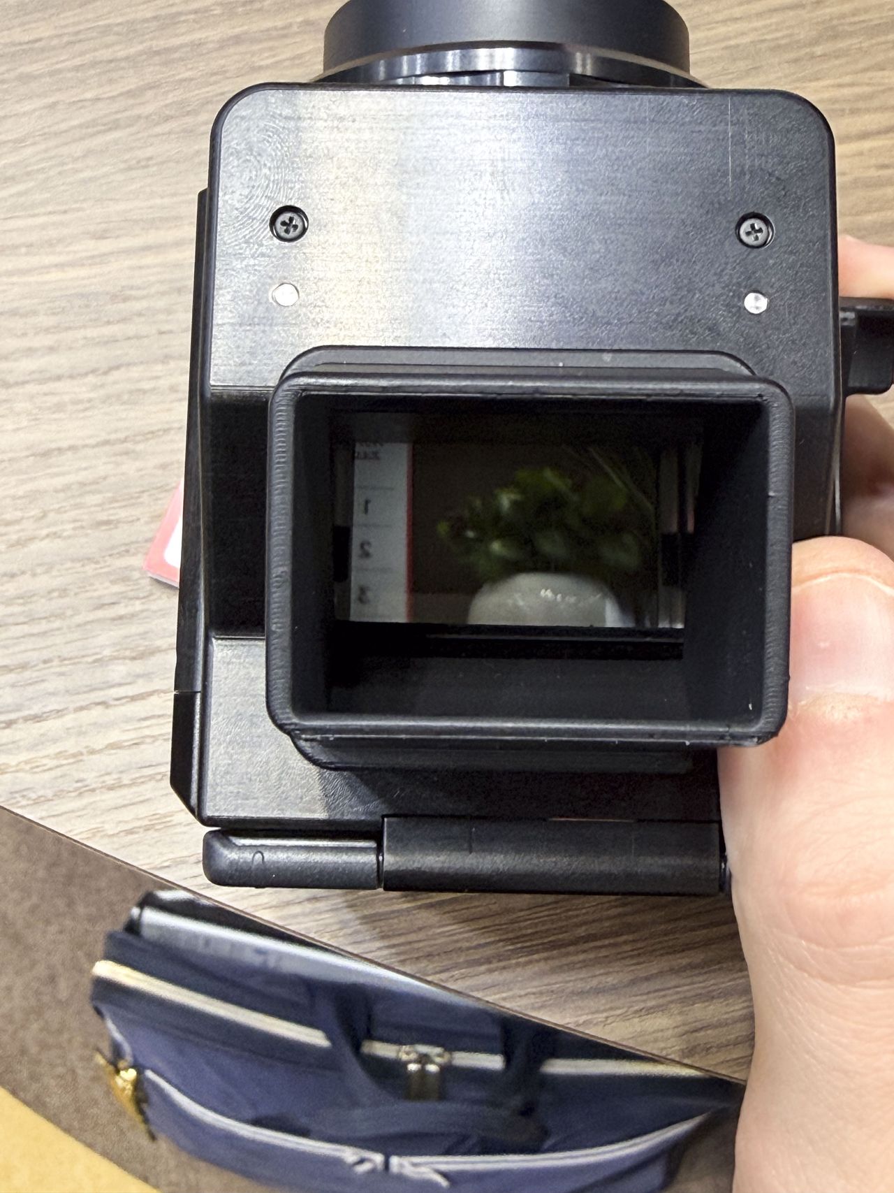 Canon's Analog Concept Camera in users hand at the Canon booth at the CP+ 2026 show
