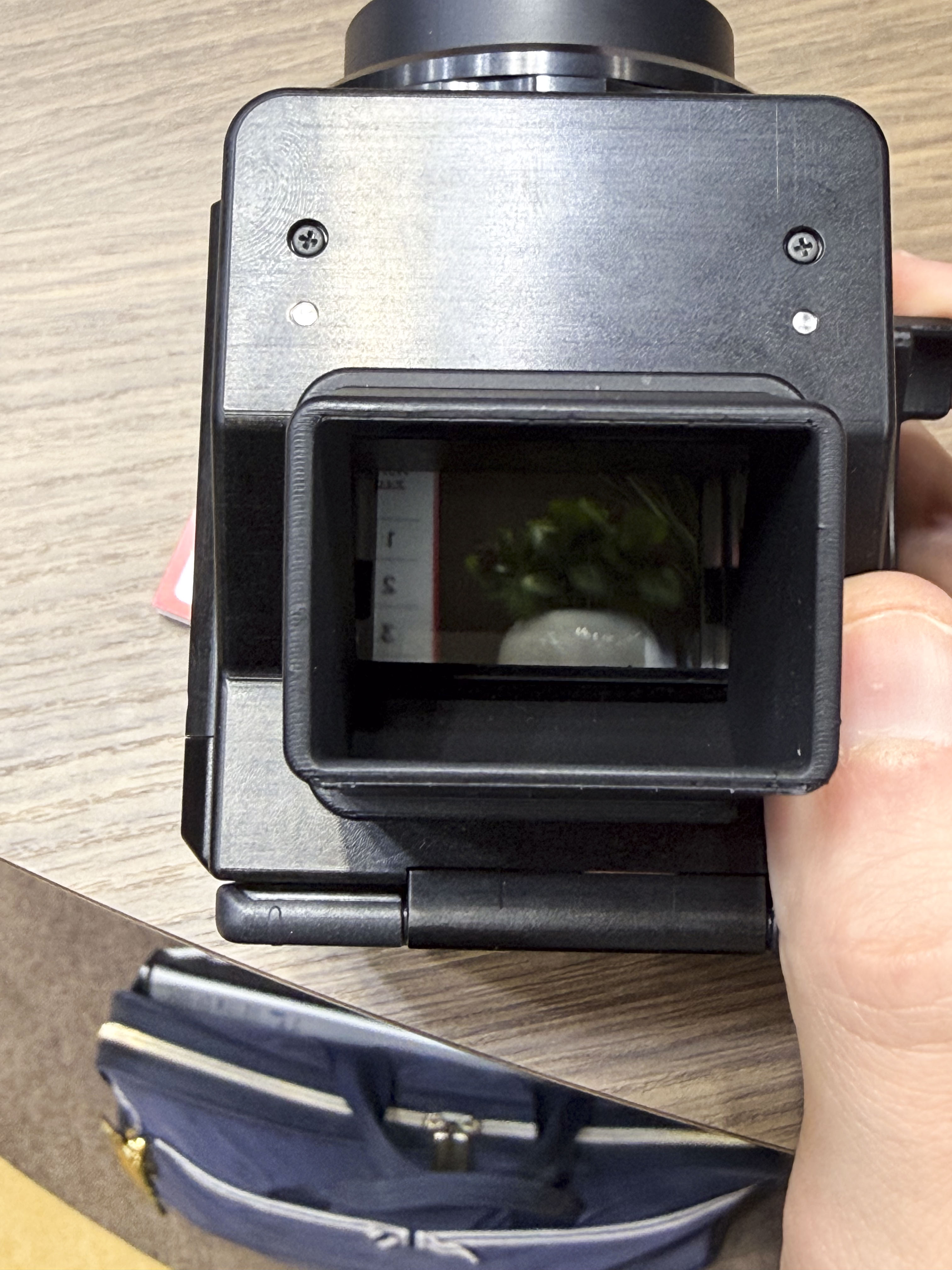 Canon's Analog Concept Camera in users hand at the Canon booth at the CP+ 2026 show