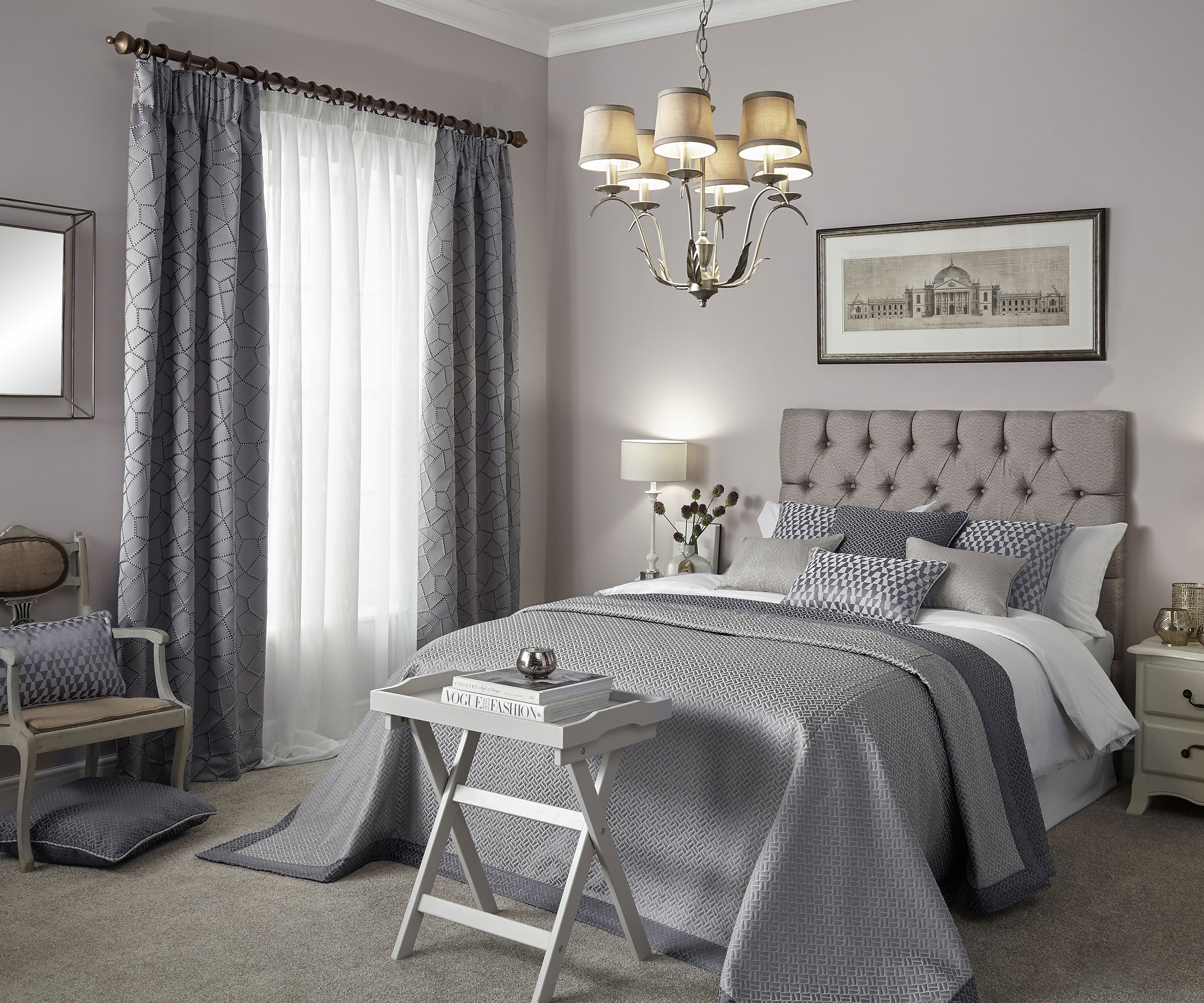 grey bedroom with side lamp and full length curtains