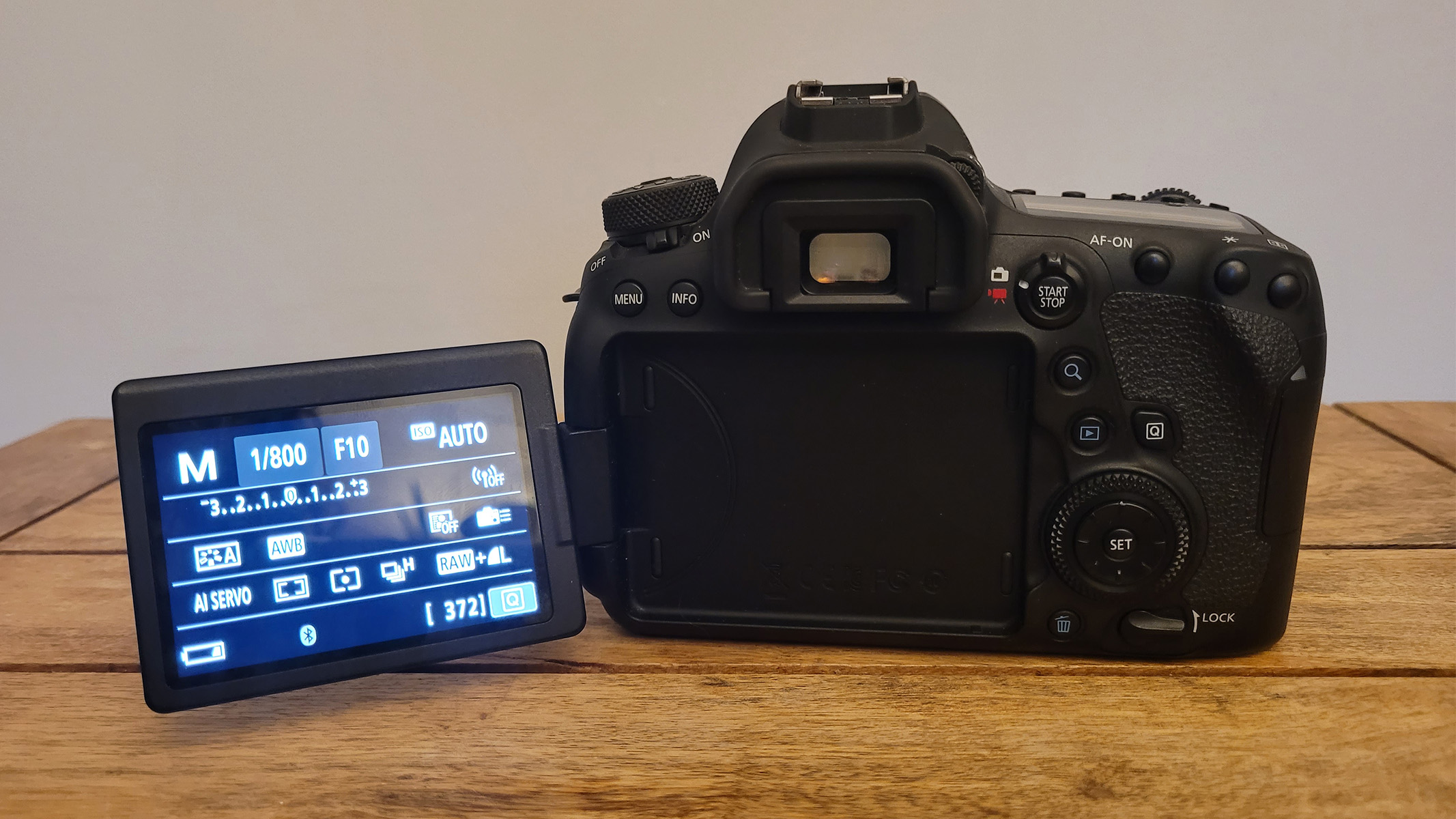 The rear of the Canon EOS 6D MK2 set atop a wooden table