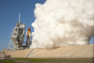 Smoke and steam rise impressively around space shuttle Discovery and Launch Pad 39A at NASA's Kennedy Space Center in Florida, as the shuttle's solid rocket boosters and main engines ignite for lift off embarking on its final mission on Feb. 24, 2011.