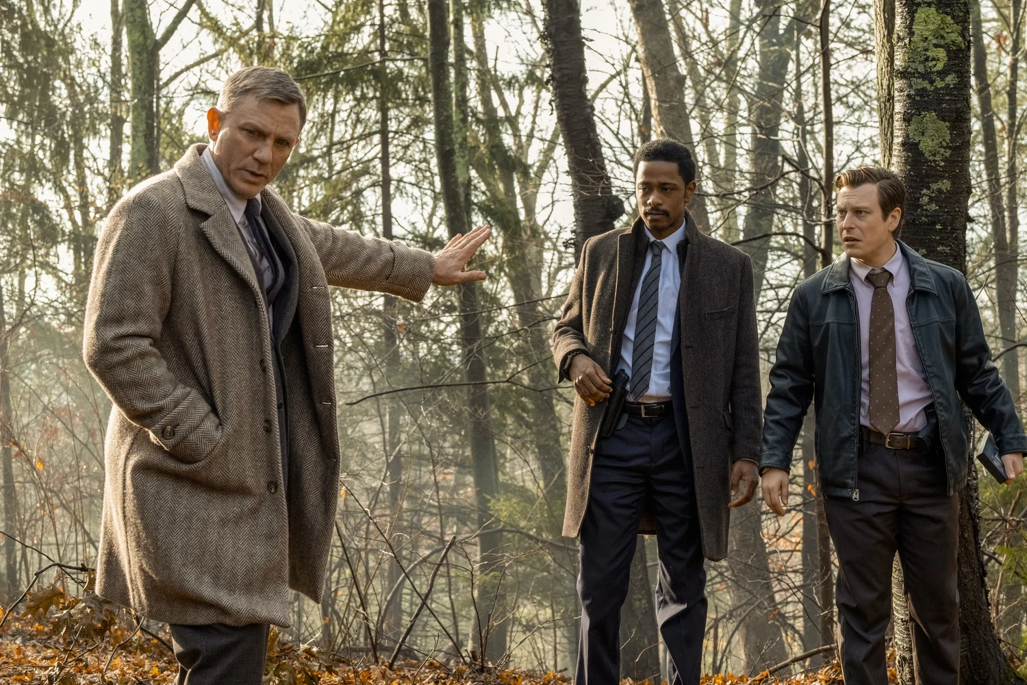 daniel craig as benoit blanc investigating in the woods giving instructions to other detectives in the original knives out