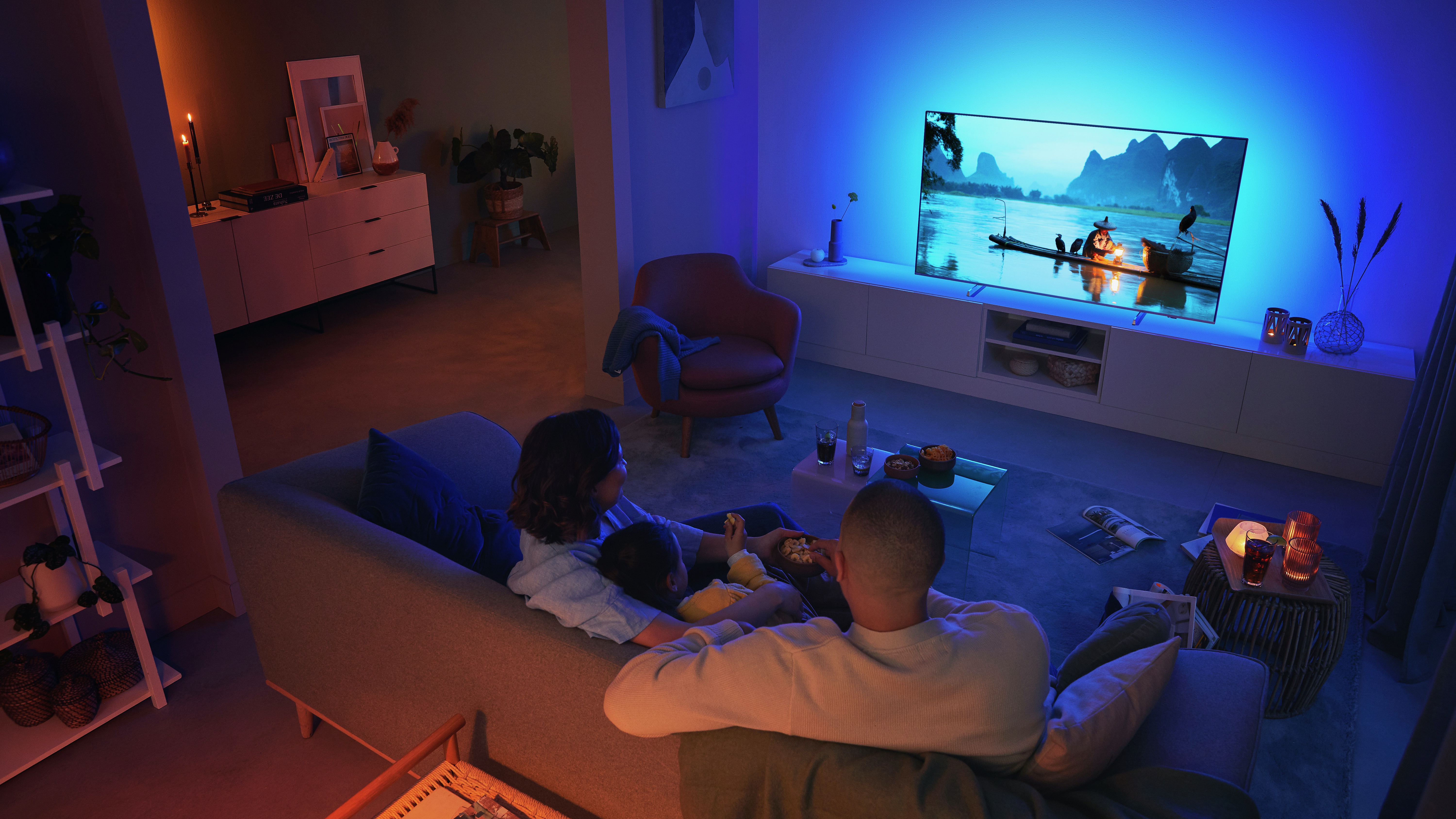 Couple watching a Philips Ambilight TV in living room
