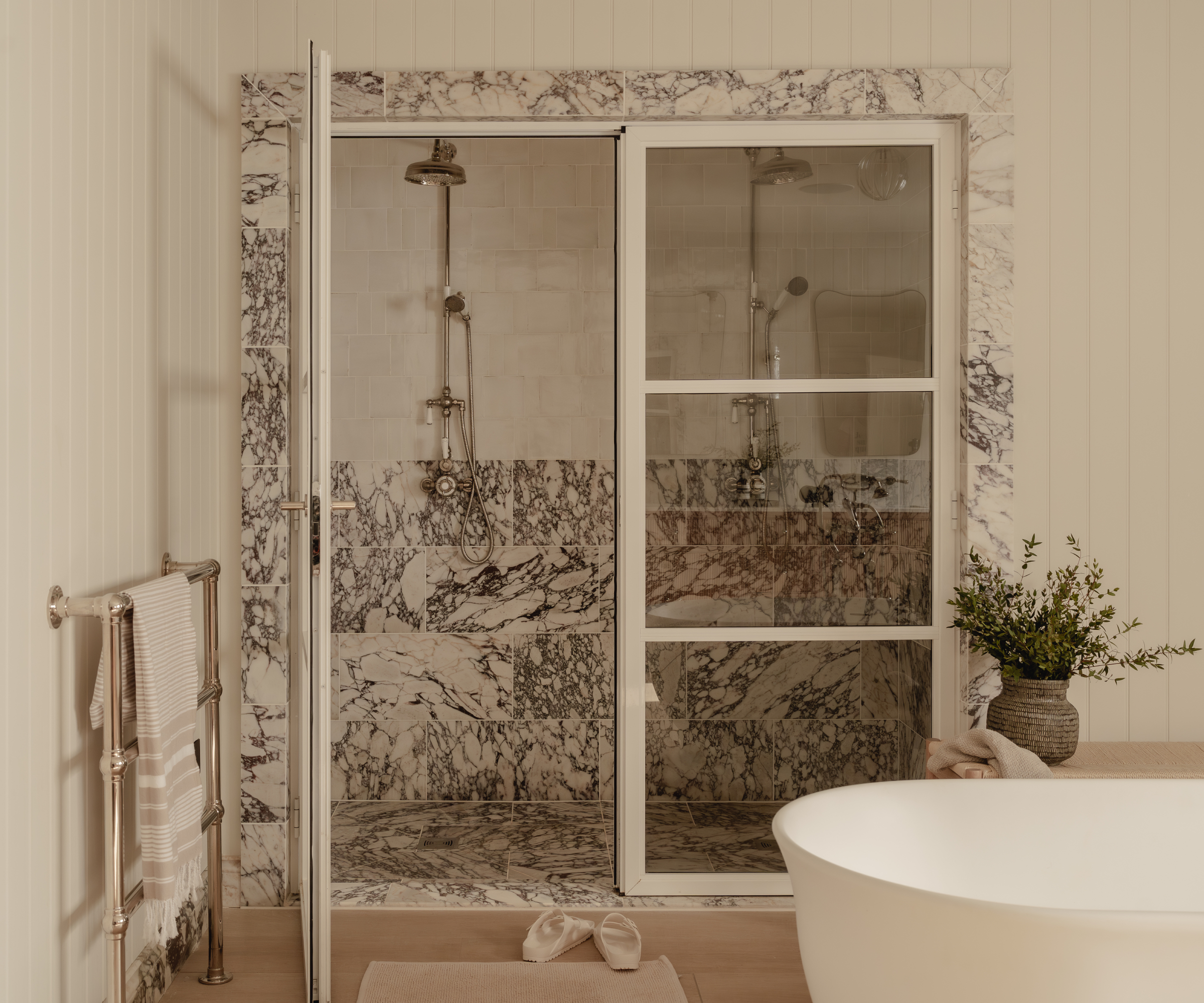 grey and white bathroom with large walk in shower and grey and white marble tiles