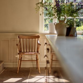 Rustic wooden chair in a cream Shaker kitchen