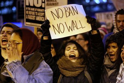 A woman protests President Trump's immigration order