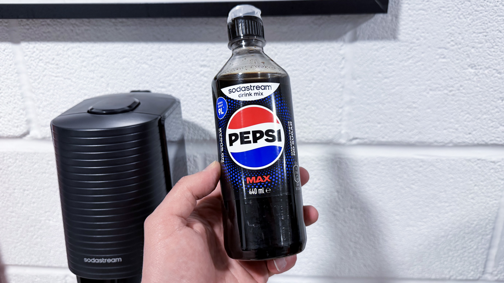A sodastream syrup bottle in hand