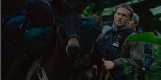 Triple Frontier Charlie Hunnam leads a donkey through the jungle