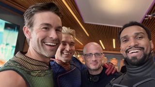 "The Boys" season 5 behind-the-scenes photo featuring actors Chace Crawford (The Deep), Anthony Starr (Homelander) and Nathan Mitchell (Black Noir II) in costume alongside showrunner Eric Kripke.