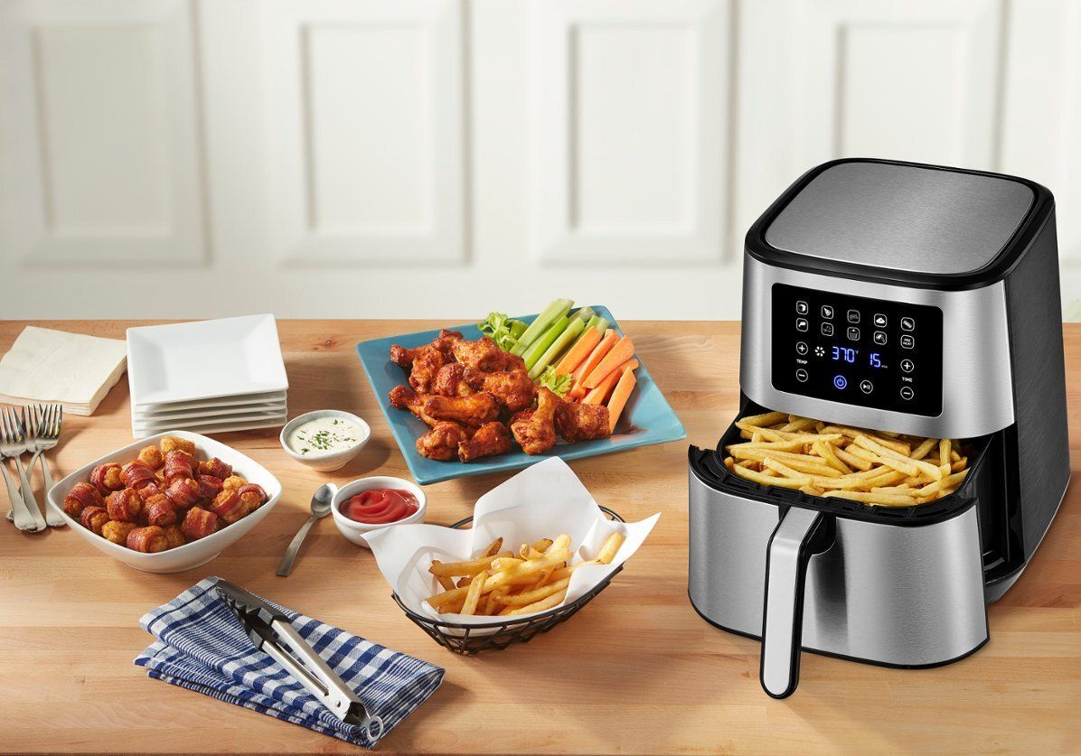 Insignia air fryer cooking meal on countertop