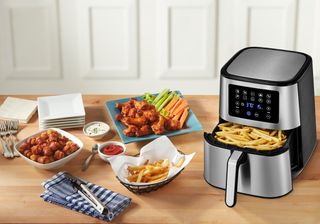 Insignia air fryer cooking meal on countertop