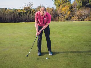 Golf Monthly Top 50 Coach John Howells hitting a putt on the green