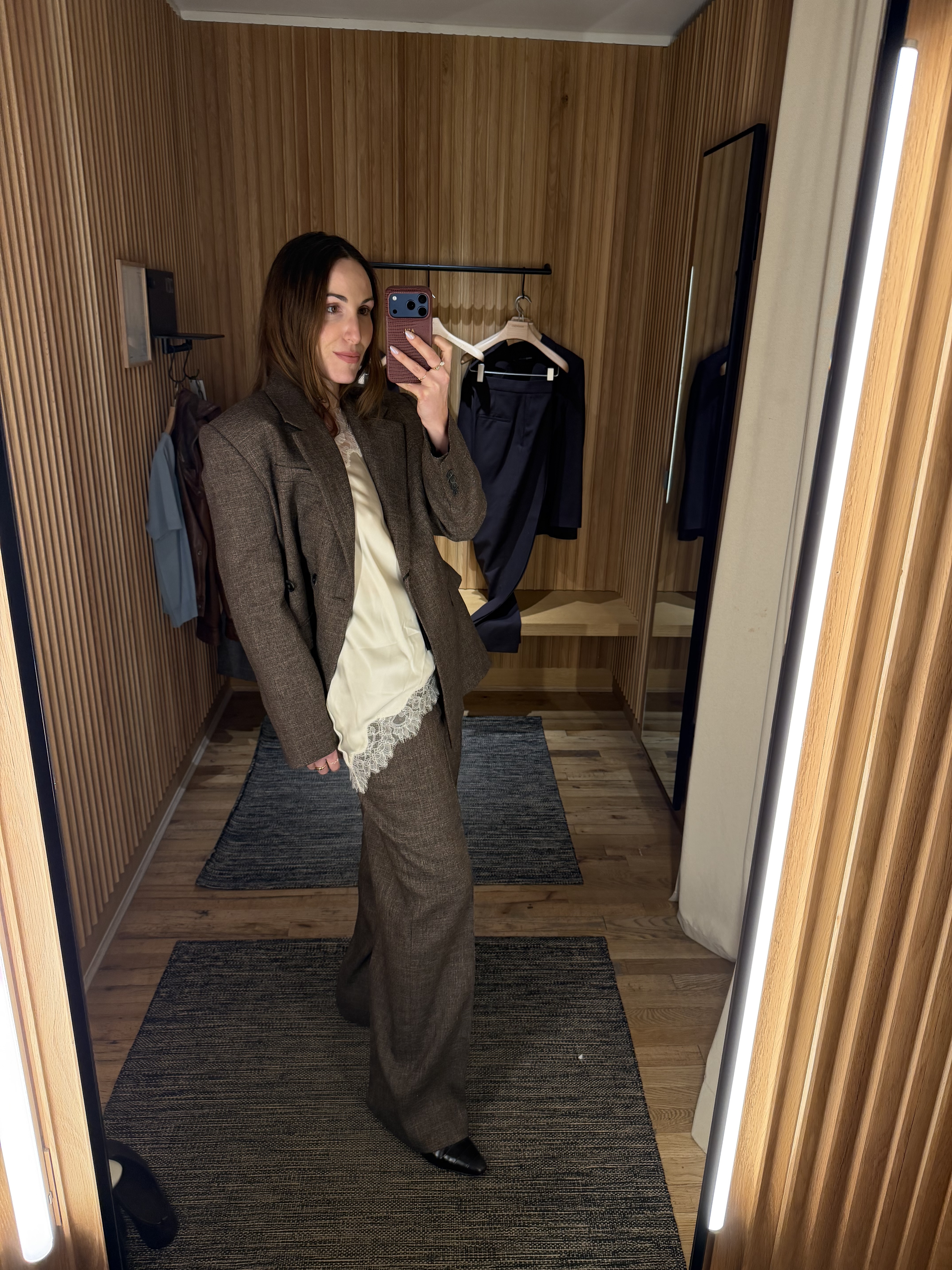 senior fashion editor Anna LaPlaca wearing Mango Selection pieces inside a store dressing room