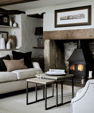 A neutral Neptune living room in a period property with exposed beams and alcove fireplace.