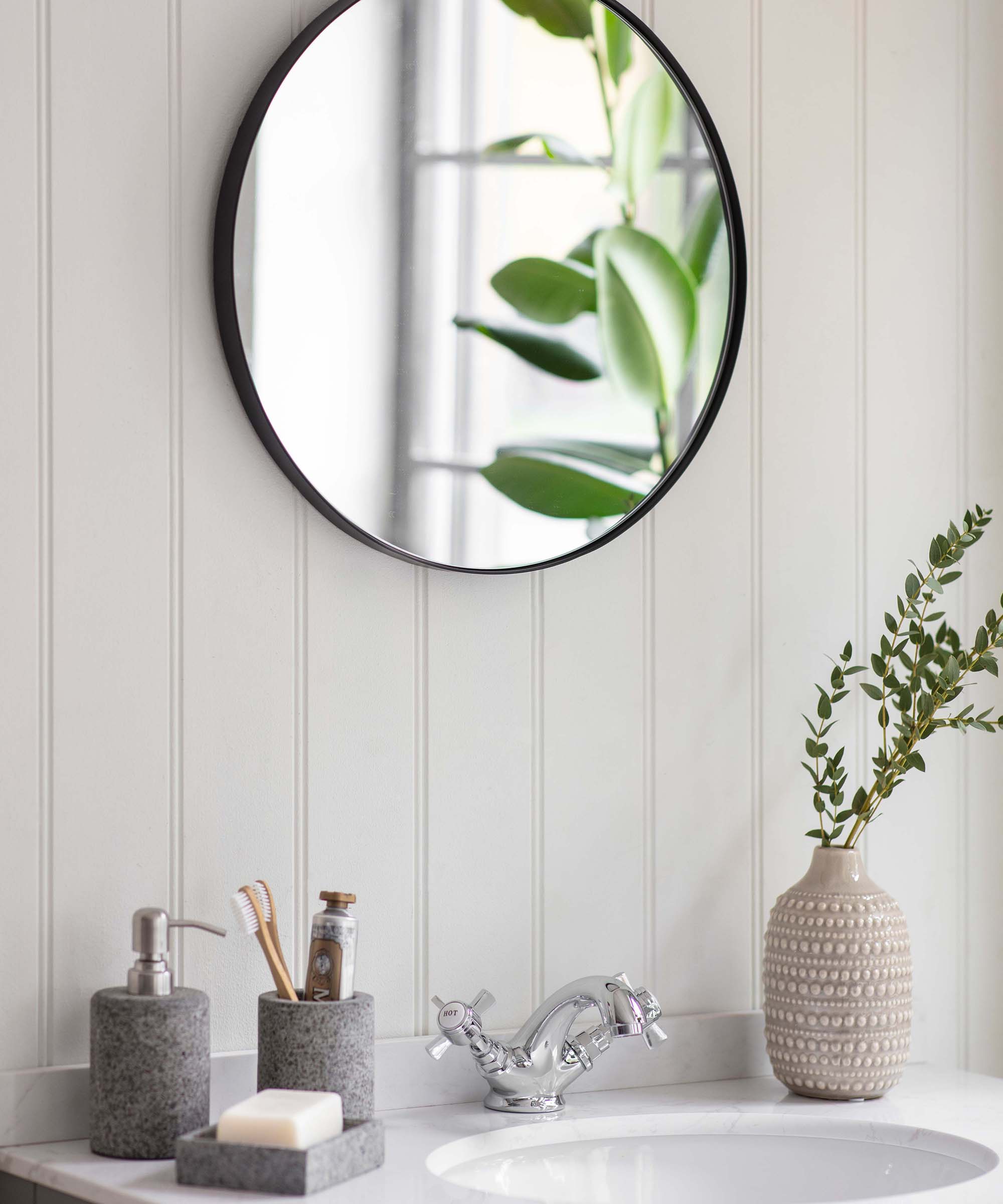 Large round mirror in bathroom by Garden Trading