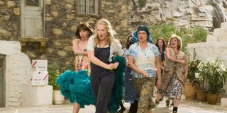 Donna (Meryl Streep) and her friends sing and dance in the streets in Mamma Mia!