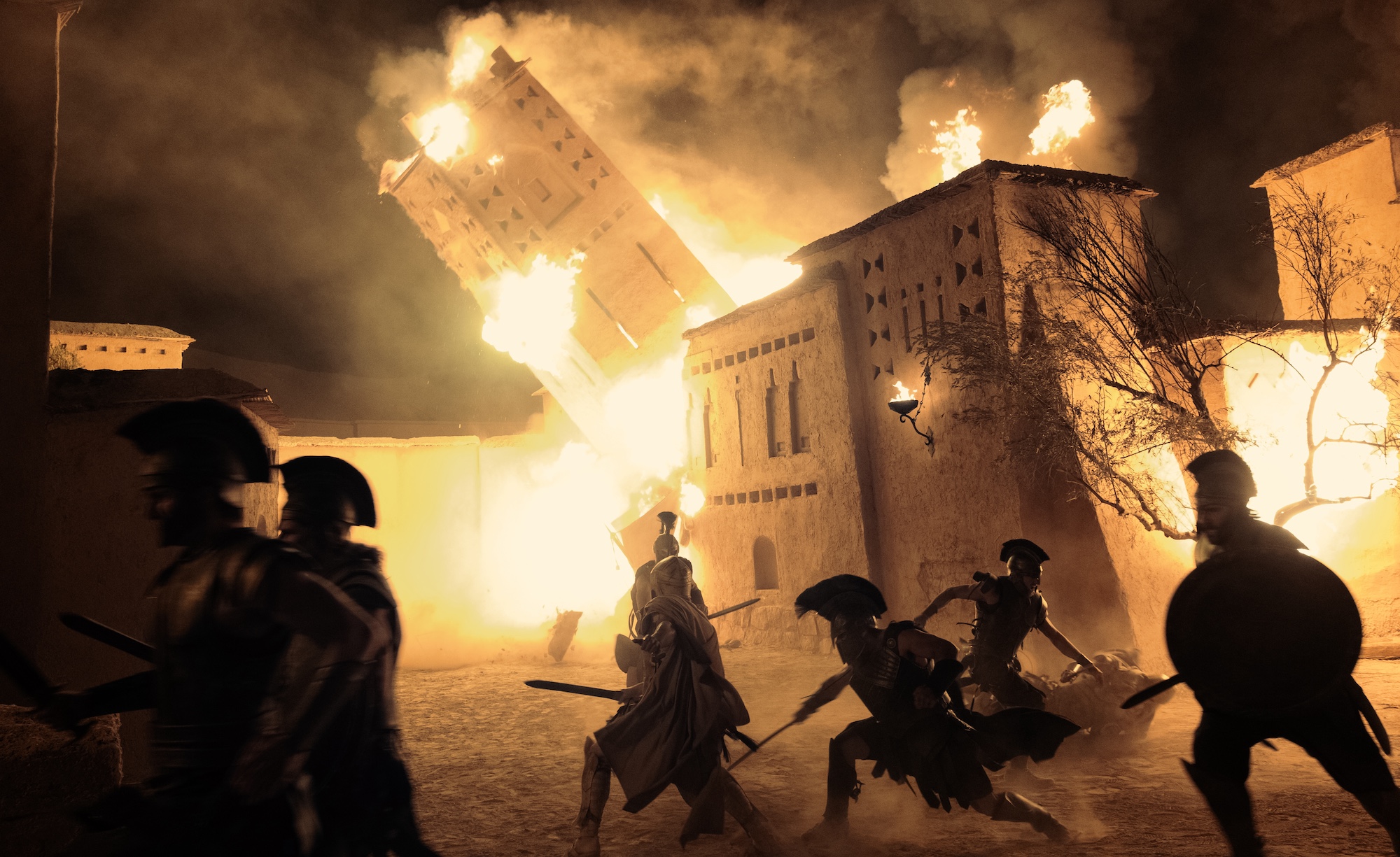 war scene at Troy with buildings on fire in THE ODYSSEY, written, produced, and directed by Christopher Nolan.