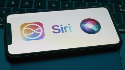 A smartphone displays the Apple Intelligence and Siri icons as it rests on a dark laptop keyboard.