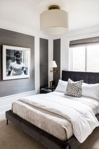 Modern grey bedroom with white bedding and throw cushions