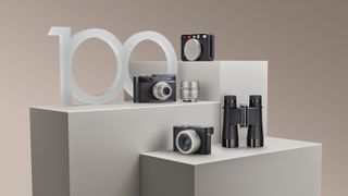 Leica cameras and binoculars arranged to celebrate 100 Years of Leica