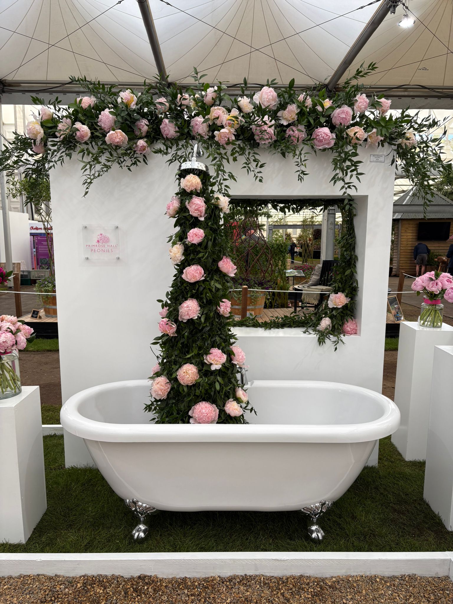 A tower of peonies rises out from a bath. Yep.