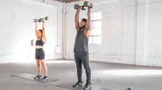 Juice and Toya performing a dumbbell press