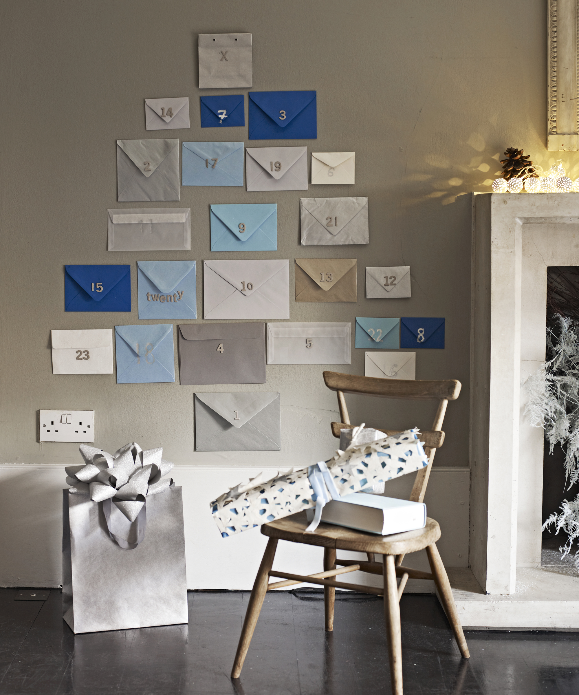 Alternative Christmas tree ideas with a tree shape made from envelopes, decorated with numbers like an Advent calendar