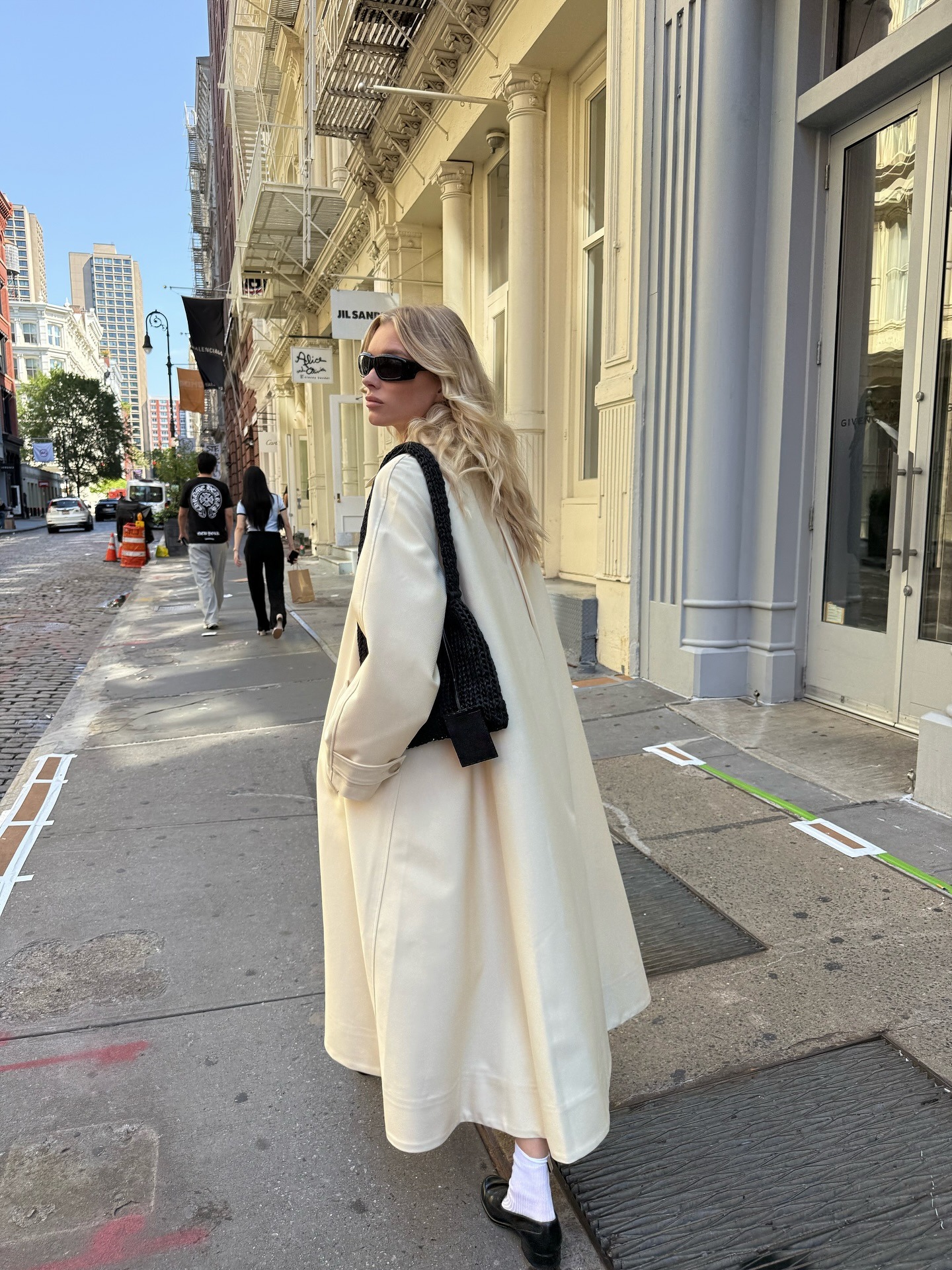 Woman wearing white ivory coat for winter 2026.
