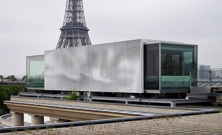 Daytime, outside view of the Nomiya Restaurant, Palais Tokyo, Paris, Eifel tower and surrounding area in the backdrop, grey sky